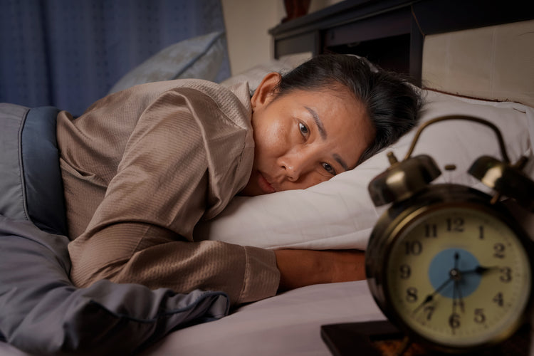 Woman lying awake in bed at night